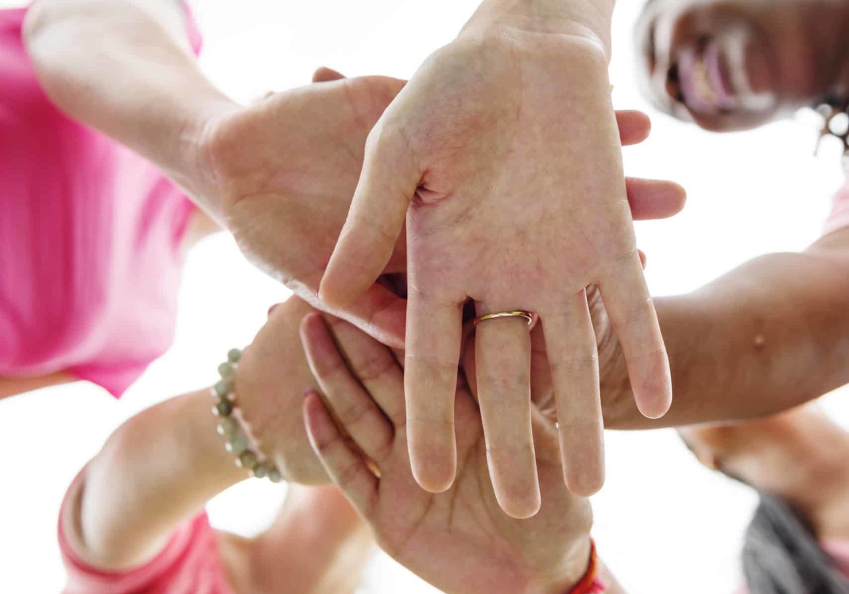 closeup-diverse-women-join-hands-together-teamwork